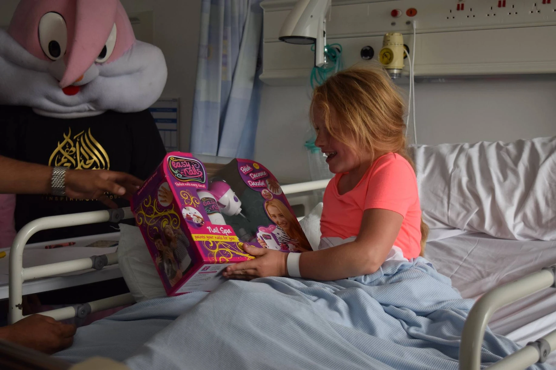 Child in a hospital being gifted a toy